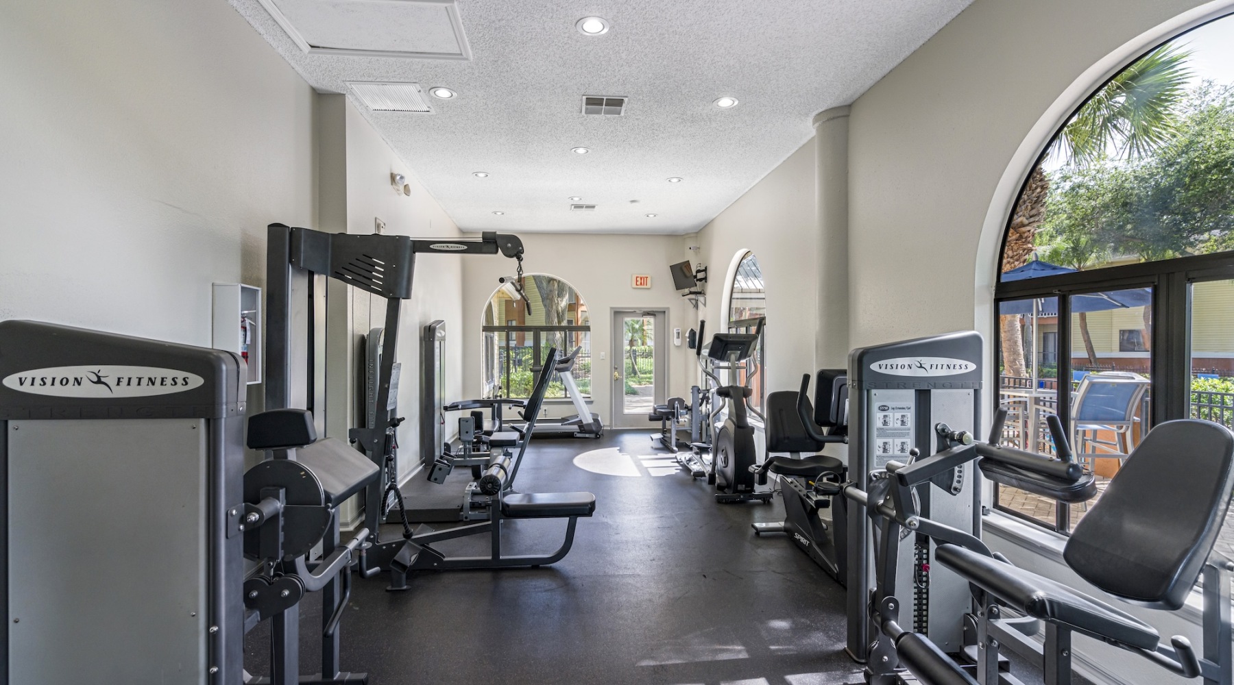 Fitness room with treadmills, bikes, on-demand fitness screen, refrigerator and water station